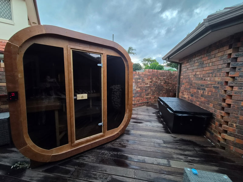 Backyard contrast therapy setup, sauna and ice bath side-by-side.